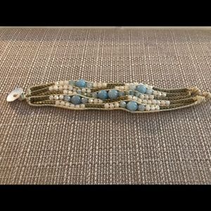 Blue and gold and cream fair trade bracelets handmade by artisans in Thailand.